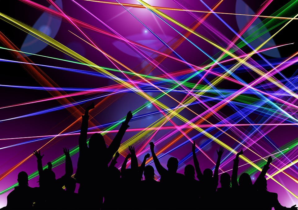 
              Stock image of laser dance party with multicolored lasers over a hazy purple background.  Silhouetted ravers in the foreground have their hands in the air, as if celebrating a good coherence theorem.
              